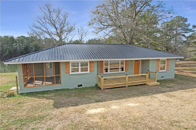 view of front facade with a sunroom and a front yard