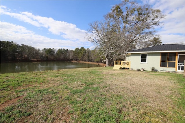 view of yard featuring a deck with water view