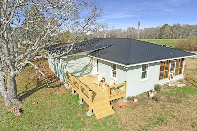 back of property featuring a yard and a deck