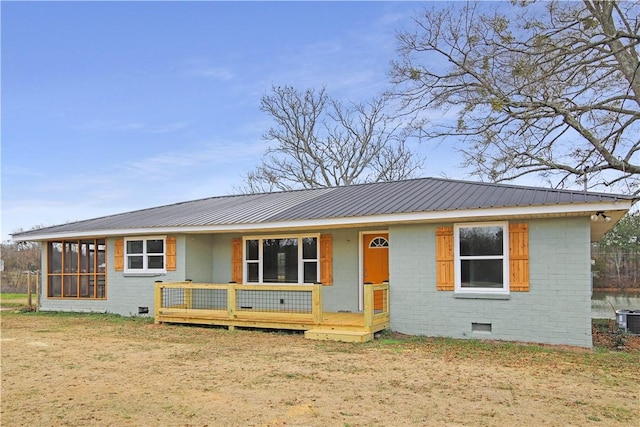 single story home with a sunroom and a front lawn