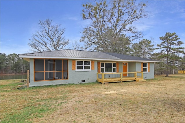 view of front of property with a sunroom, a deck, and a front lawn