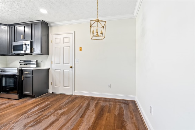 kitchen with dark wood finished floors, crown molding, light countertops, appliances with stainless steel finishes, and baseboards