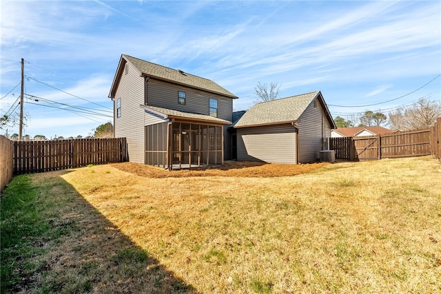 back of house with a sunroom, a fenced backyard, a lawn, and central AC