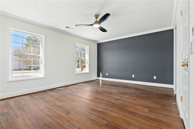 interior space with a textured ceiling, visible vents, dark wood-type flooring, and ornamental molding