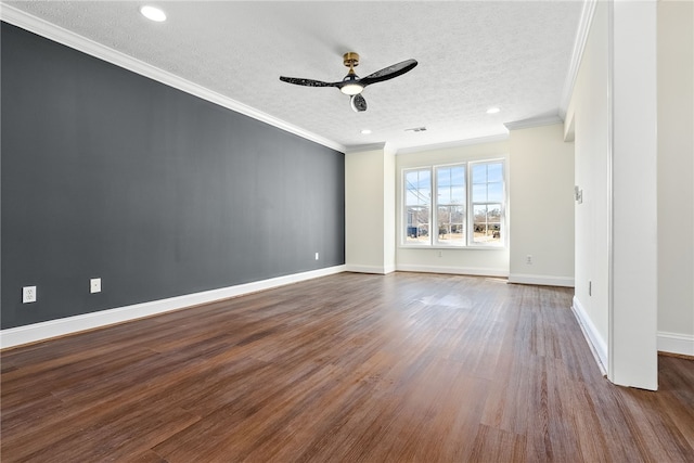 spare room with baseboards, a ceiling fan, ornamental molding, dark wood-type flooring, and a textured ceiling