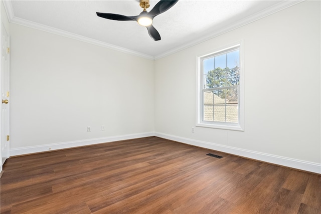 empty room featuring ceiling fan, wood finished floors, visible vents, and crown molding