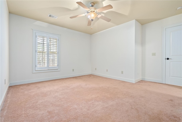 unfurnished room with baseboards, light carpet, visible vents, and ceiling fan