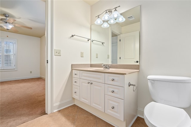 bathroom with visible vents, ceiling fan, toilet, tile patterned floors, and vanity