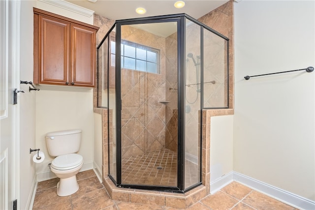 full bathroom with baseboards, toilet, a shower stall, and tile patterned flooring