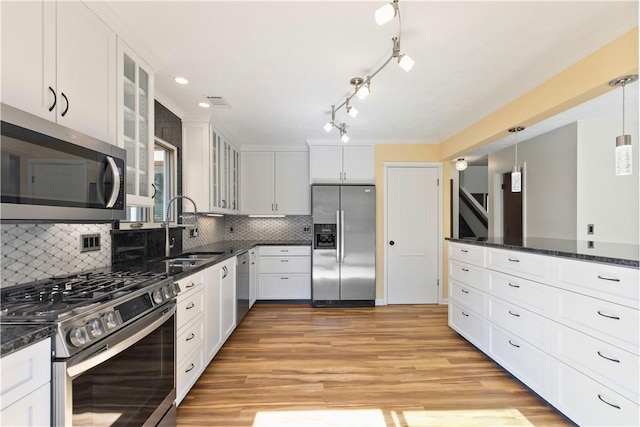 kitchen featuring stainless steel appliances, a sink, white cabinets, and light wood-style floors