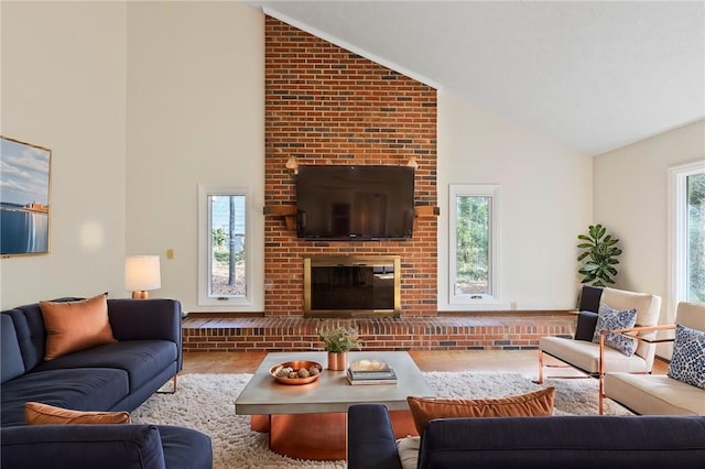 living room with a brick fireplace and high vaulted ceiling