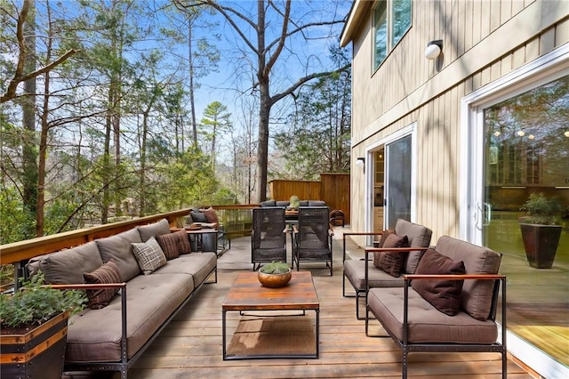 wooden deck with outdoor dining area and outdoor lounge area