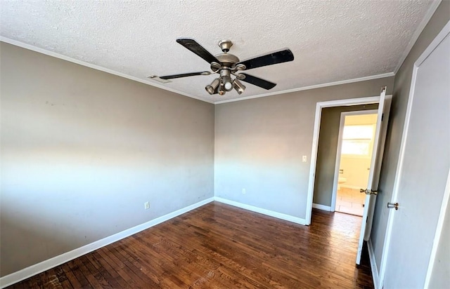 empty room featuring a textured ceiling, dark wood-type flooring, ornamental molding, and ceiling fan