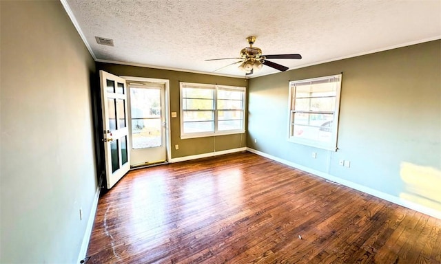 spare room featuring crown molding, ceiling fan, wood-type flooring, and a textured ceiling