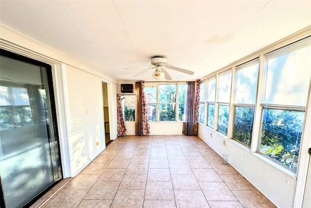 unfurnished sunroom with ceiling fan