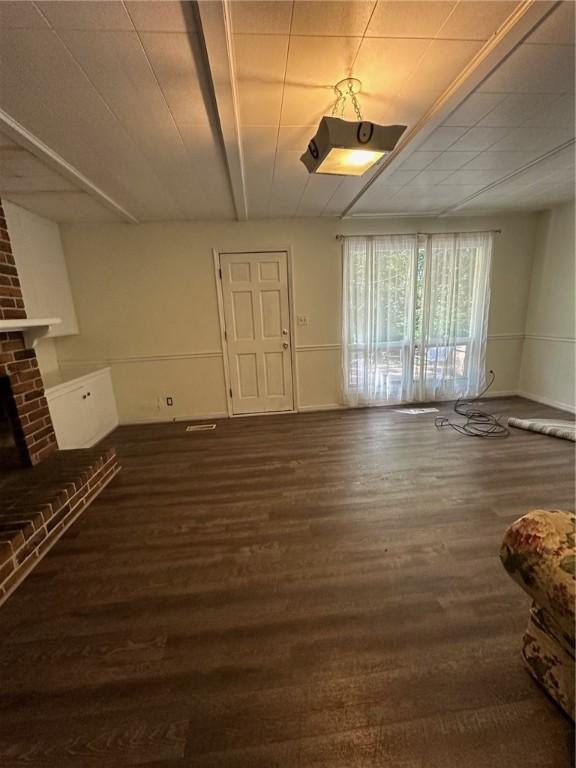 467 Southview Dr, Auburn, AL 36830 - unfurnished living room with a fireplace and dark wood-type flooring