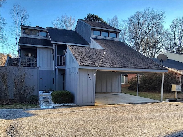 view of front of property with driveway, a residential view, and a carport