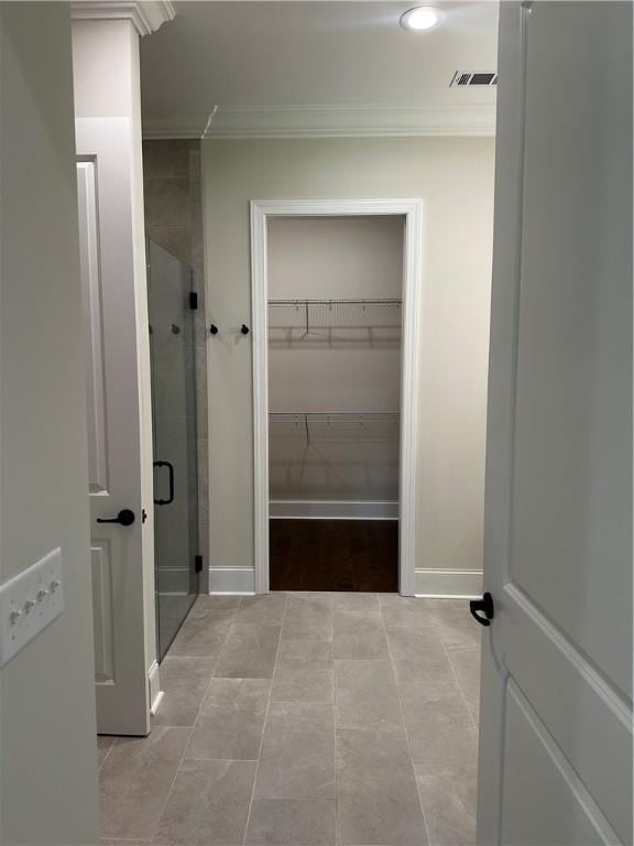 489 Windsor Dr, Opelika, AL 36801 - bathroom with crown molding, a shower stall, and a spacious closet