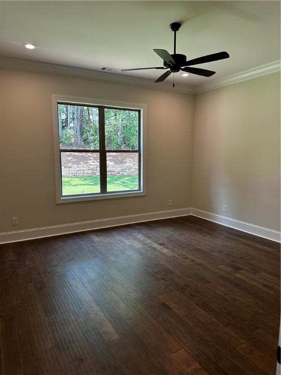 489 Windsor Dr, Opelika, AL 36801 - spare room featuring crown molding, dark wood-type flooring, ceiling fan, and recessed lighting