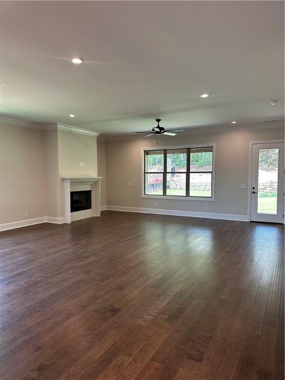 489 Windsor Dr, Opelika, AL 36801 - unfurnished living room with crown molding, ceiling fan, dark wood-style floors, recessed lighting, and a fireplace