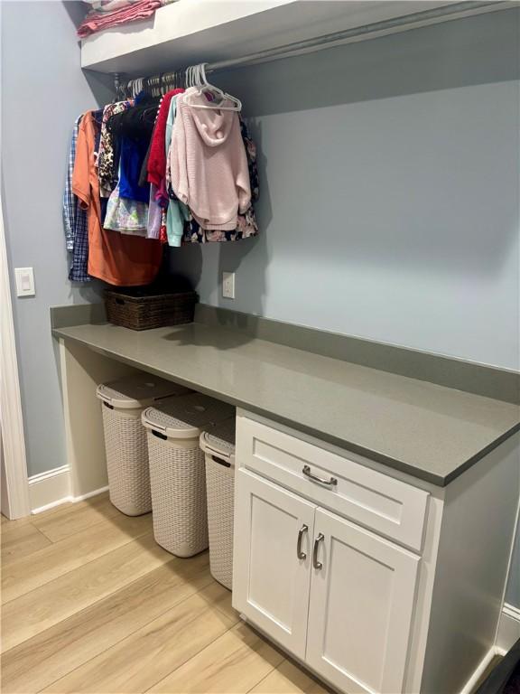 mudroom featuring light wood-type flooring and baseboards