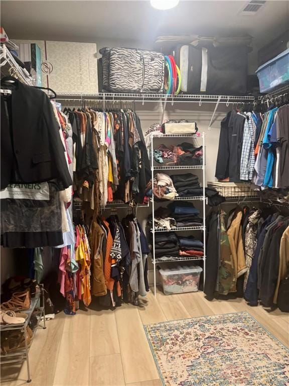 spacious closet featuring visible vents and wood finished floors