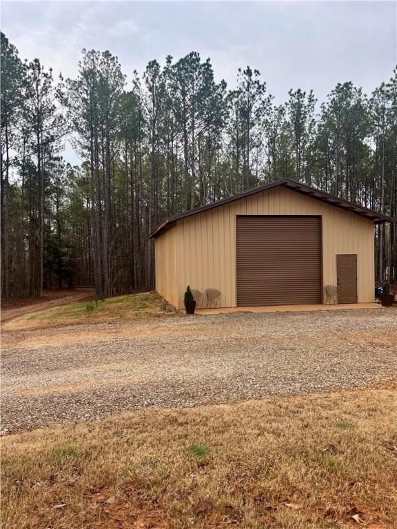 detached garage with gravel driveway