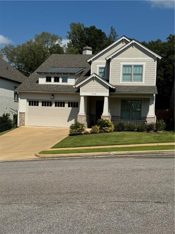 view of front of property with a garage and a front lawn