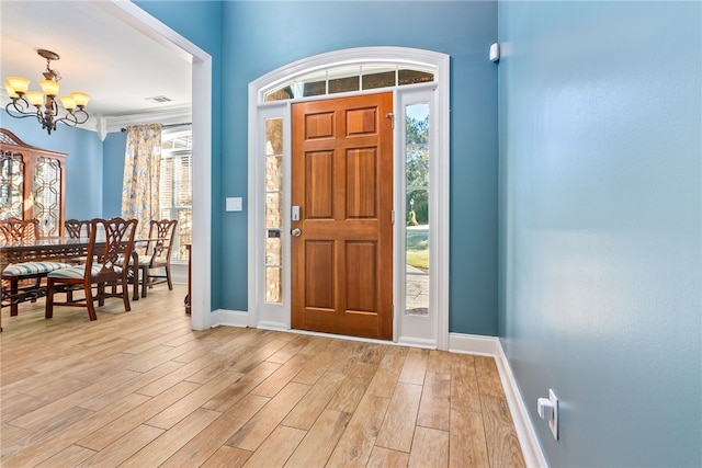 foyer with a chandelier and light hardwood / wood-style flooring