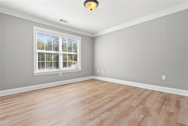 unfurnished room with light wood-type flooring and crown molding