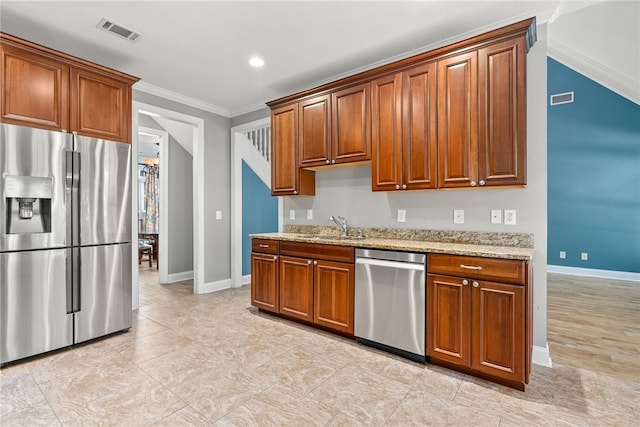 kitchen with light stone countertops, stainless steel appliances, ornamental molding, and sink