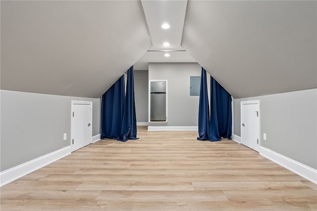 bonus room with light hardwood / wood-style flooring and vaulted ceiling