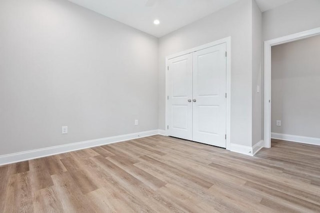 unfurnished bedroom with light hardwood / wood-style floors and a closet