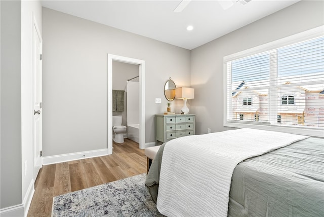 bedroom with recessed lighting, baseboards, ensuite bath, a ceiling fan, and wood finished floors