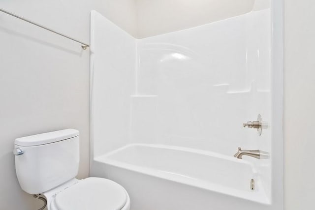 bathroom featuring shower / bath combination and toilet