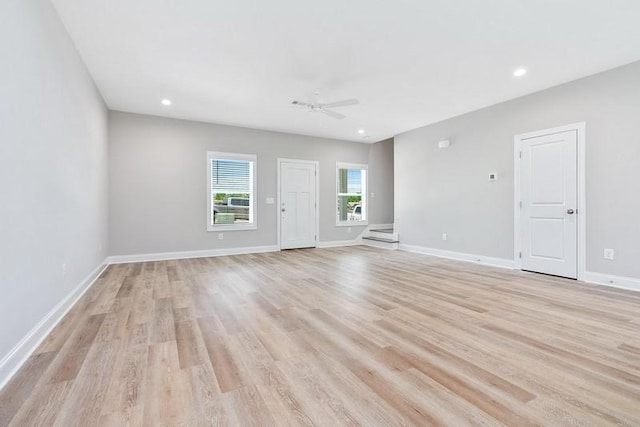 spare room featuring ceiling fan and light hardwood / wood-style floors