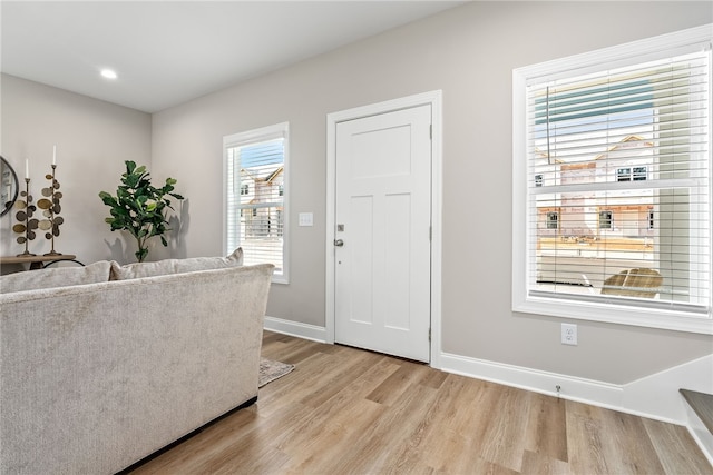 interior space with baseboards, recessed lighting, and light wood-type flooring