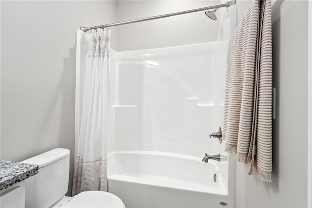 bathroom featuring toilet, shower / bath combo, and vanity