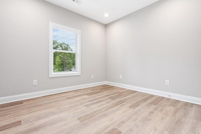 unfurnished room with light wood-type flooring