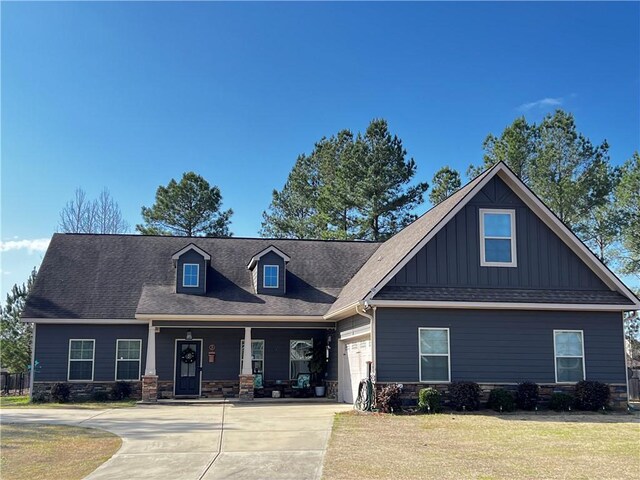 view of front of property featuring a porch and a garage