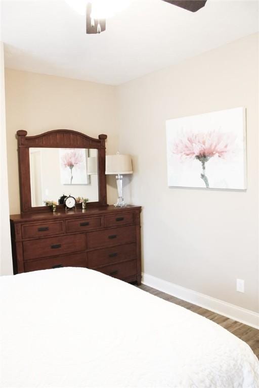 bedroom featuring ceiling fan and dark hardwood / wood-style floors