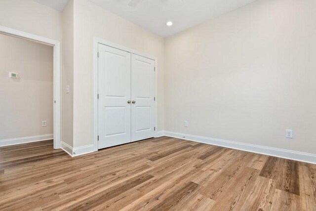 3260 Academy Dr Unit 510, Opelika, AL 36801 - unfurnished bedroom featuring light wood finished floors, baseboards, a closet, and recessed lighting