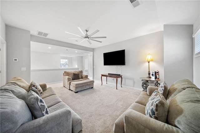 carpeted living area with visible vents, a ceiling fan, and baseboards