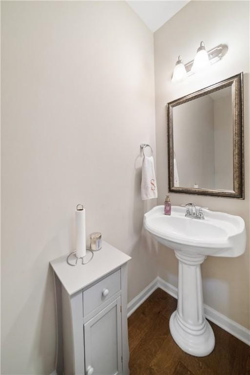 bathroom with baseboards and wood finished floors