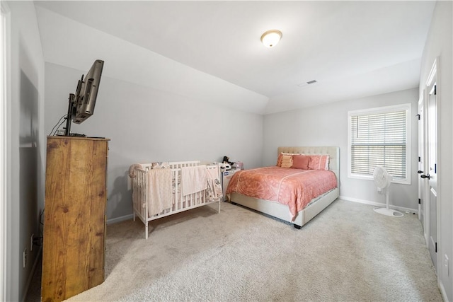 carpeted bedroom featuring visible vents, baseboards, and lofted ceiling