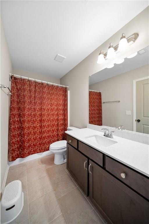 bathroom featuring tile patterned floors, toilet, vanity, and a shower with curtain