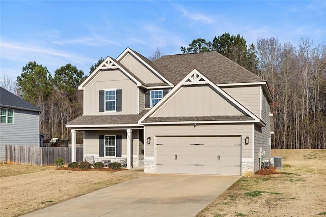 craftsman-style home with board and batten siding, central AC, driveway, and fence