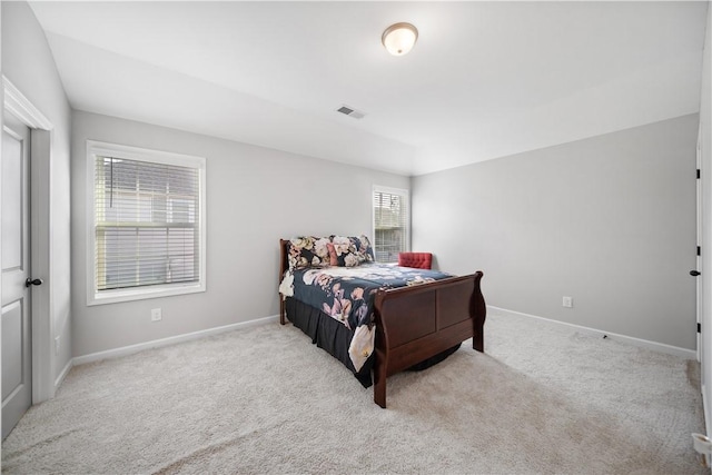 carpeted bedroom featuring visible vents and baseboards