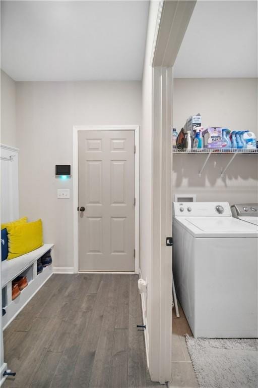 laundry room featuring baseboards, separate washer and dryer, wood finished floors, and laundry area