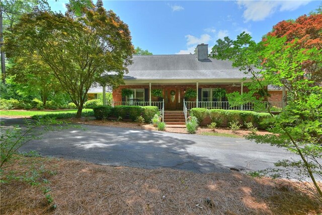 1765 Creekwood Trl, Auburn, AL 36830 - view of front of house featuring covered porch and a chimney